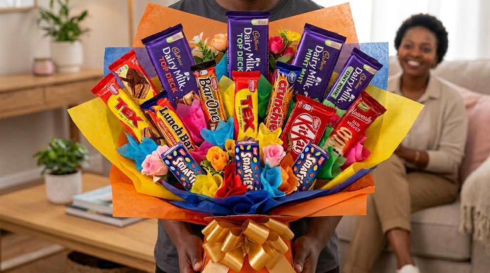 Chocolate bouquet of Cadbury, Tex, KitKat, Lunch Bar and Smarties bars wrapped in coloured paper with a gold bow