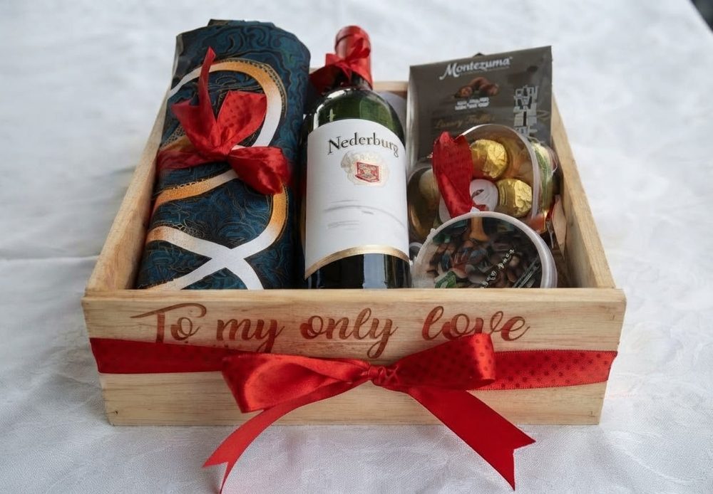 Wooden crate engraved To my only love with Nederburg wine, Montezuma truffles, chocolates and a red ribbon