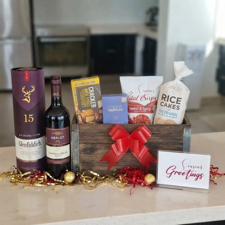 Rustic wooden crate hamper with single malt whisky, merlot, crackers, truffles and crisps